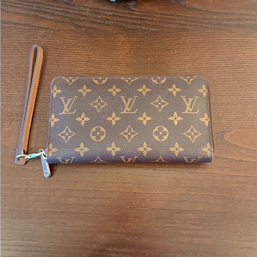 Louis Vuitton Zippy Brown Monogram Wallet with unbranded wristlet strap.